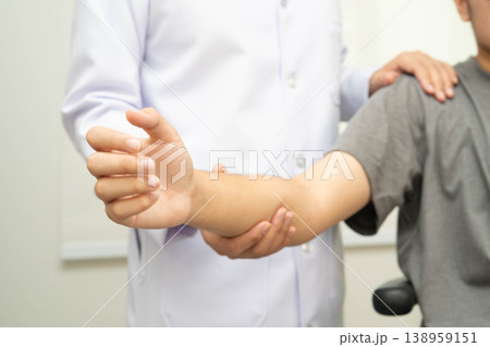 Physical therapy, Asian therapist doctor treat perform pain young man in hospital. Physical therapy, Asian therapist doctor treat perform pain young man in hospital. 138959151