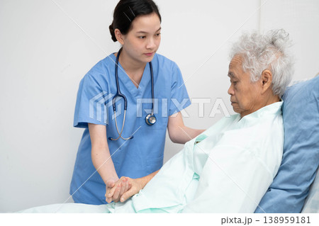 Asian doctor checking and treat elderly woman patient health in hospital. 138959181
