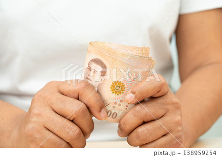Asian woman counting Thai baht banknote money, investment economy, accounting business and banking. Asian woman counting Thai baht banknote money, investment economy, accounting business and banking. 138959254