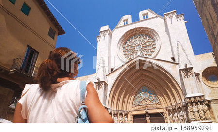Woman tourist admiring Tarragona Cathedral Gothic architecture Woman tourist admiring Tarragona Cathedral Gothic architecture 138959291
