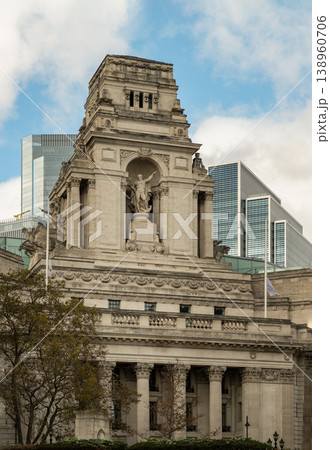 The stately Portland stone of Ten Trinity Square commands the scene, its intricate carvings and Corinthian columns embodying Beaux-Arts grandeur. Atop the great tower, a colossal statue of Old Father The stately Portland stone of Ten Trinity Square commands the scene, its intricate carvings and Corinthian columns embodying Beaux-Arts grandeur. Atop the great tower, a colossal statue of Old Father 138960706