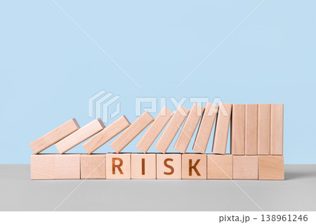 Wooden blocks on a table with the word risk. Risk assessment crisis concept. Financial analysis solution, real estate business management. Plan to stop economic risk. Wooden blocks on a table with the word risk. Risk assessment crisis concept. Financial analysis solution, real estate business management. Plan to stop economic risk. 138961246