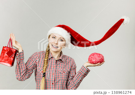 Christmas woman holding shopping bag and brain Christmas woman holding shopping bag and brain 138961274
