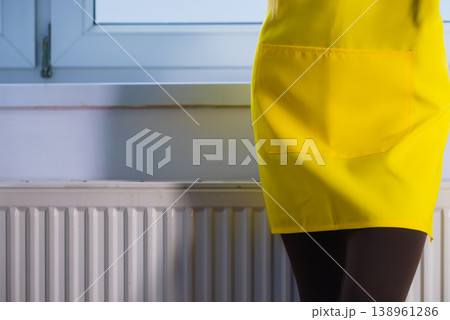 Person wearing yellow apron 138961286