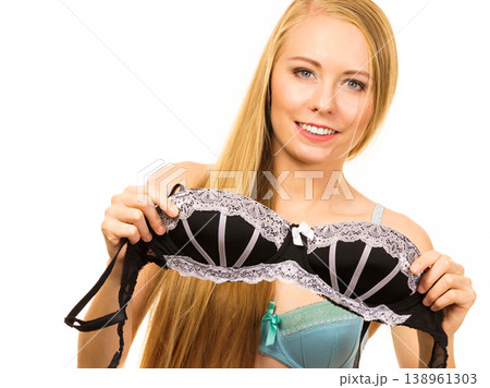 Woman trying on black bra with lace Woman trying on black bra with lace 138961303