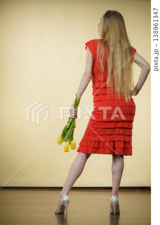 woman with yellow tulips bunch, back view woman with yellow tulips bunch, back view 138961347