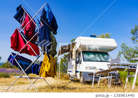Clothes hanging to dry outdoors by camping car. Caravan vacation. 138961440