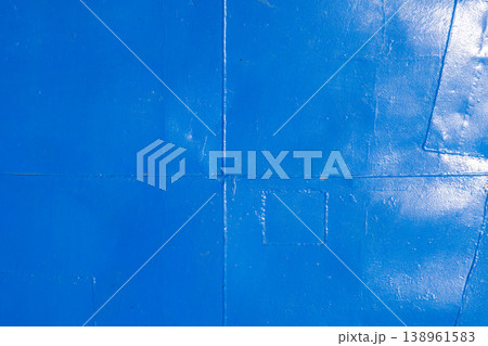 Weathered metal deck floor with welded seams ant thick layer of blue paint. 138961583