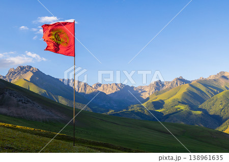 Kyrgyzstan valley with red national flag and mountain range 138961635