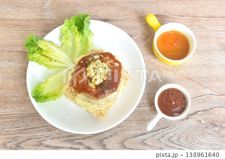 fried pork Hamburg steak topping fried rice butter with cos lettuce on plate dipping sauce fried pork Hamburg steak topping fried rice butter with cos lettuce on plate dipping sauce 138961640