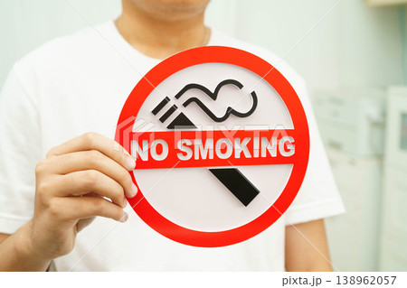 Male holding a no smoking sign. 138962057