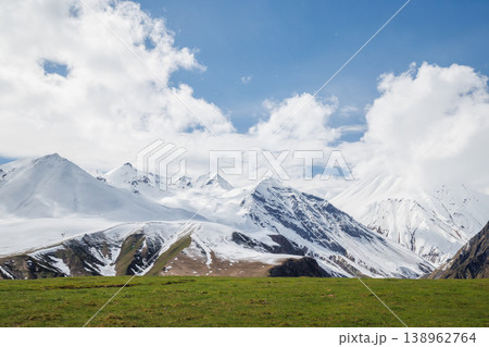 Snow covered mountains under blue sky 138962764
