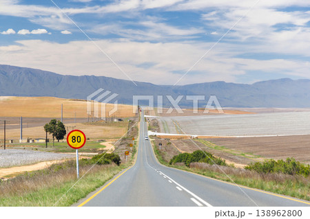 Asphalt road in South Africa surrounded by fields Asphalt road in South Africa surrounded by fields 138962800