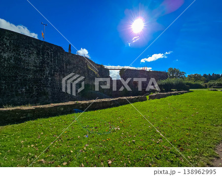 Scenic view of old stone fortifications and a hiking trail on a moody overcast day. Scenic view of old stone fortifications and a hiking trail on a moody overcast day. 138962995