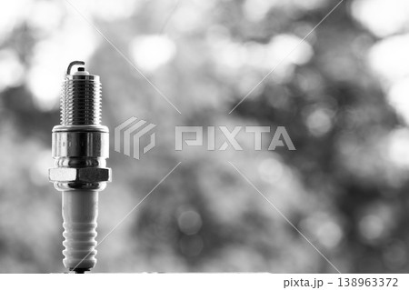Auto service. New spark plug as spare part of car. Auto service. New spark plug as spare part of car. 138963372