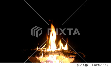 The hot embers of burning wood log fire isolated on black. Firewood burning on stove. The hot embers of burning wood log fire isolated on black. Firewood burning on stove. 138963635