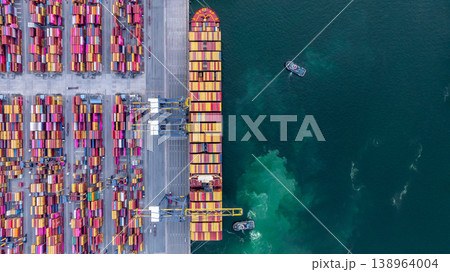 Aerial view container cargo ship at deep sea port terminal with tugboat assisting container cargo ship, Global trade and maritime supply chain, Logistics and transportation freight business industry. Aerial view container cargo ship at deep sea port terminal with tugboat assisting container cargo ship, Global trade and maritime supply chain, Logistics and transportation freight business industry. 138964004