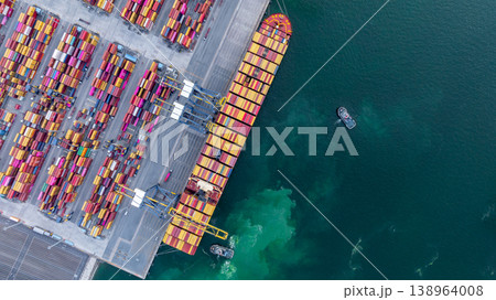 Aerial view container cargo ship at deep sea port terminal with tugboat assisting container cargo ship, Global trade and maritime supply chain, Logistics and transportation freight business industry. Aerial view container cargo ship at deep sea port terminal with tugboat assisting container cargo ship, Global trade and maritime supply chain, Logistics and transportation freight business industry. 138964008