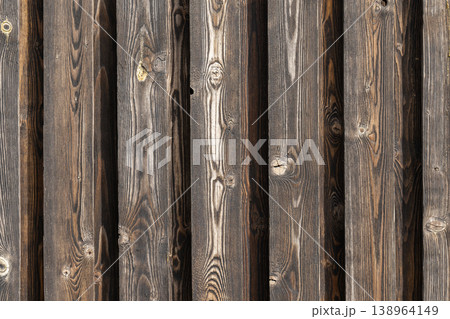 Weathered vertical wooden planks form a rustic fence wall Weathered vertical wooden planks form a rustic fence wall 138964149