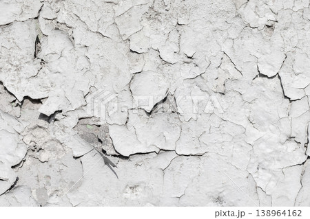 Peeling white paint and cracked plaster, background texture Peeling white paint and cracked plaster, background texture 138964162