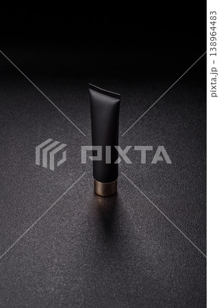 Black empty plastic tube for cream, paste, or shampoo as a mockup. An empty cosmetic tube mockup Black empty plastic tube for cream, paste, or shampoo as a mockup. An empty cosmetic tube mockup 138964483