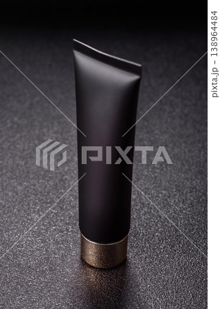 Black empty plastic tube for cream, paste, or shampoo as a mockup. An empty cosmetic tube mockup Black empty plastic tube for cream, paste, or shampoo as a mockup. An empty cosmetic tube mockup 138964484