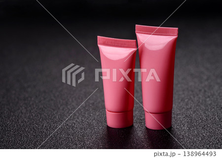 Pink empty plastic tube for cream, paste or shampoo as a mockup. Empty cosmetic tube mockup Pink empty plastic tube for cream, paste or shampoo as a mockup. Empty cosmetic tube mockup 138964493