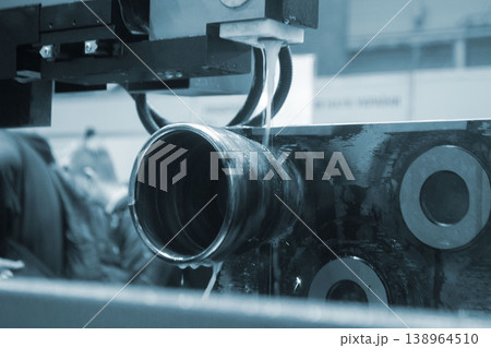 Wire-cut electrical discharge machine. Operation of wire-EDM machine cutting metal parts. Electrical discharge machine EDM cutting metal workpiece. Cutting process by wire cut machine. Metalworking 138964510