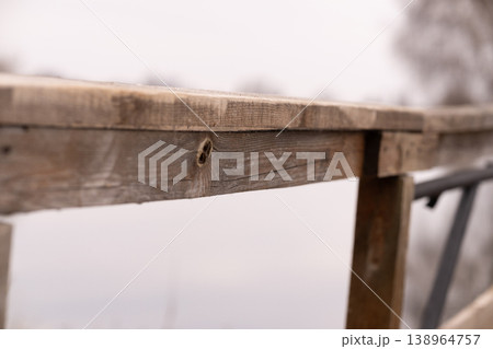 Close Up of Weathered Wooden Railing Against Soft Blurred Background in Natural Light Close Up of Weathered Wooden Railing Against Soft Blurred Background in Natural Light 138964757
