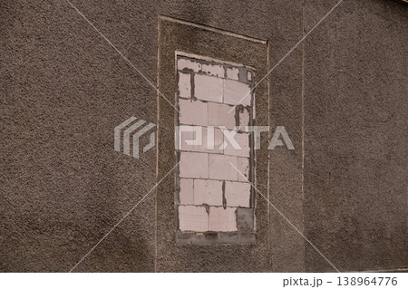 Closed Window with White Bricks in Textured Brown Wall Background 138964776