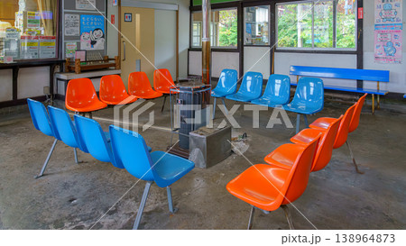 Muroran, Hokkaido, Japan - Oct 04 2024, close-up view of the waiting room with chairs placed around the potbelly stove, at one of the stations in Muroran, Japan Muroran, Hokkaido, Japan - Oct 04 2024, close-up view of the waiting room with chairs placed around the potbelly stove, at one of the stations in Muroran, Japan 138964873