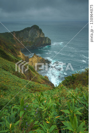 Muroran, Hokkaido, Japan - Oct 04 2024, vertical aerial view of the picturesque Pacific ocean coast with sharp cliffs and high mountain slopes, in a storm, it's raining, at daytime, Muroran, Japan Muroran, Hokkaido, Japan - Oct 04 2024, vertical aerial view of the picturesque Pacific ocean coast with sharp cliffs and high mountain slopes, in a storm, it's raining, at daytime, Muroran, Japan 138964875