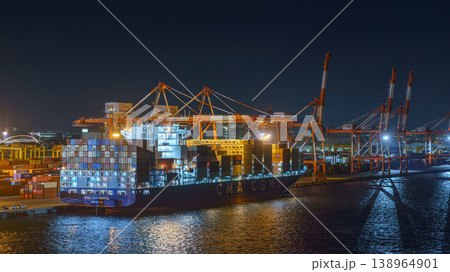 Osaka, Japan - Oct 11 2024, panoramic view from the sea to the dorky commercial port of Osaka with a heavily loaded dry cargo ship from CMA CGM moored at night, Osaka, Japan Osaka, Japan - Oct 11 2024, panoramic view from the sea to the dorky commercial port of Osaka with a heavily loaded dry cargo ship from CMA CGM moored at night, Osaka, Japan 138964901