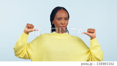 Portrait, attitude and a pointing black woman with confidence in studio on a gray background. Face, frown and expression with a young person looking serious about her fashion or style choice Portrait, attitude and a pointing black woman with confidence in studio on a gray background. Face, frown and expression with a young person looking serious about her fashion or style choice 138965102
