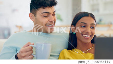 Couple, laptop and coffee on couch, laugh or reading for funny story, notification or post on web. Man, woman and computer for meme, streaming comic movie or happy on social network website in home Couple, laptop and coffee on couch, laugh or reading for funny story, notification or post on web. Man, woman and computer for meme, streaming comic movie or happy on social network website in home 138965115