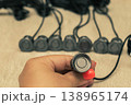 Grey parking sensors with wires on the concrete surface 138965174