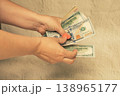 Money is in women's hands. The girl counts the money. 138965177