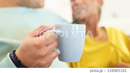 Coffee cup, closeup and couple on couch for drink, conversation and relax together in home living room. Man, woman and zoom of tea, coco or espresso in lounge, sofa and talking with bonding in house. Coffee cup, closeup and couple on couch for drink, conversation and relax together in home living room. Man, woman and zoom of tea, coco or espresso in lounge, sofa and talking with bonding in house. 138965181