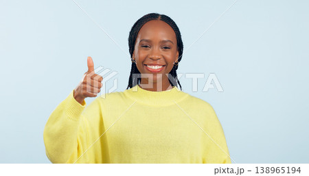Portrait, opportunity and black woman with thumbs up, support and decision on a blue studio background. Face, African person and model with hand gesture, sign and feedback with review and emoji Portrait, opportunity and black woman with thumbs up, support and decision on a blue studio background. Face, African person and model with hand gesture, sign and feedback with review and emoji 138965194