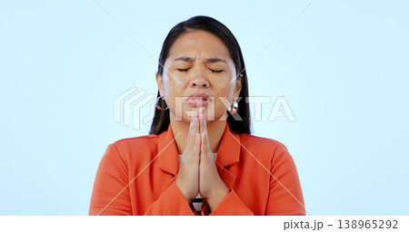 Hope, religion and woman with faith, praying and gratitude on a blue studio background. Person, girl and model with gesture, prayer and spirit with guidance, Christian and emoji with stress and peace 138965292