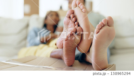 Couple, feet and box for relaxing in new home for moving with investment for future, growth and love. Man, woman and together in bond, comfort or trust for real estate, property agreement or purchase 138965294