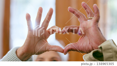 Closeup, home and senior couple with heart hands, support and romance with retirement, relationship and care. Apartment, elderly man and old woman with symbol for love, marriage and romantic with joy 138965305