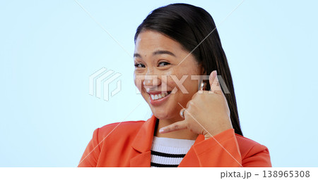 Woman, smile and call me with hand or sign, networking and portrait in studio by blue background. Happy asian model, contact us and emoji for communication, gesture and icon for telephone in mockup Woman, smile and call me with hand or sign, networking and portrait in studio by blue background. Happy asian model, contact us and emoji for communication, gesture and icon for telephone in mockup 138965308