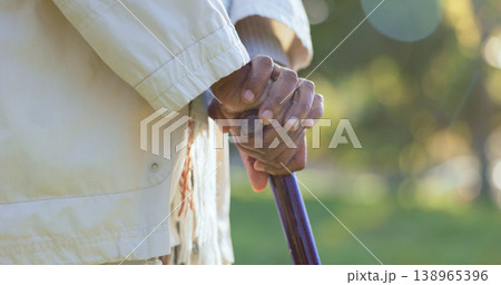 Hands, walking stick and person with disability outdoor for rehabilitation, support or help in retirement. Closeup, sick senior and cane for balance of parkinson, arthritis and healthcare aid in park Hands, walking stick and person with disability outdoor for rehabilitation, support or help in retirement. Closeup, sick senior and cane for balance of parkinson, arthritis and healthcare aid in park 138965396