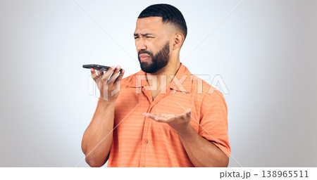 Man in studio with phone, voice call and frustrated with connection problem for communication. Discussion, anger and confused person on smartphone conversation, scam or phishing on white background. Man in studio with phone, voice call and frustrated with connection problem for communication. Discussion, anger and confused person on smartphone conversation, scam or phishing on white background. 138965511