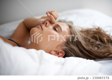 Sleeping, peace and tired woman relax in a bed calm, resting and dreaming in her home or apartment. Fatigue, face female person lying in bedroom for burnout recovery, nap or weekend comfort in house Sleeping, peace and tired woman relax in a bed calm, resting and dreaming in her home or apartment. Fatigue, face female person lying in bedroom for burnout recovery, nap or weekend comfort in house 138965578