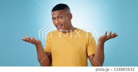 Confused, portrait and man in studio shrug with emoji hands or asking body language on blue background. Why, face and male model with palm scale questions, doubt or comparison, balance or dont know 138965632