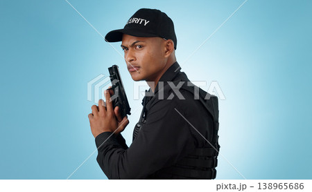 Man, security guard and holding gun for shooting, protection and hands with face, portrait or confident. Safety, service or weapon for criminal, law or studio background for pistol, crime or eyes 138965686