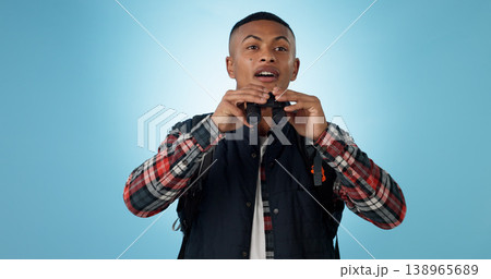 Travel, hiking and man with binocular search in a studio with freedom, adventure or adventure on blue background. Camping, bird watching and male traveler with seeing equipment for exploring nature Travel, hiking and man with binocular search in a studio with freedom, adventure or adventure on blue background. Camping, bird watching and male traveler with seeing equipment for exploring nature 138965689