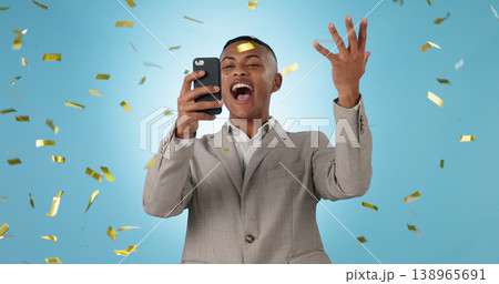 Business man, phone and winning with confetti celebration, stock market news or competition winner in studio. Young trader in wow, surprise and excited for profit or sale on mobile on blue background 138965691